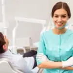 dentist with patient in dental chair